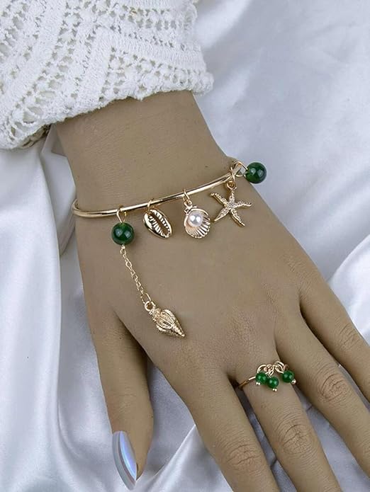 Gold bracelet featuring a starfish charm and a ring, ideal for adding a touch of seaside style.
