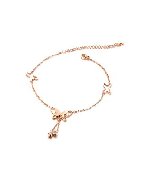 Butterfly necklace in rose gold on marble table, stylish and delicate.