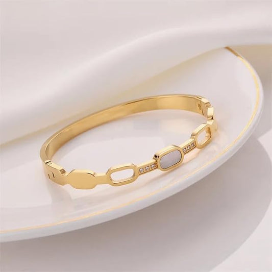 Stylish gold bracelet adorned with white stones, perfect for formal events.