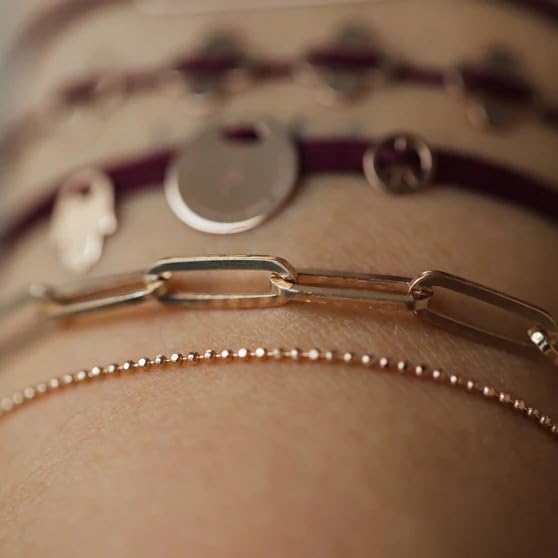 Fashionable gold accessory with delicate chain.