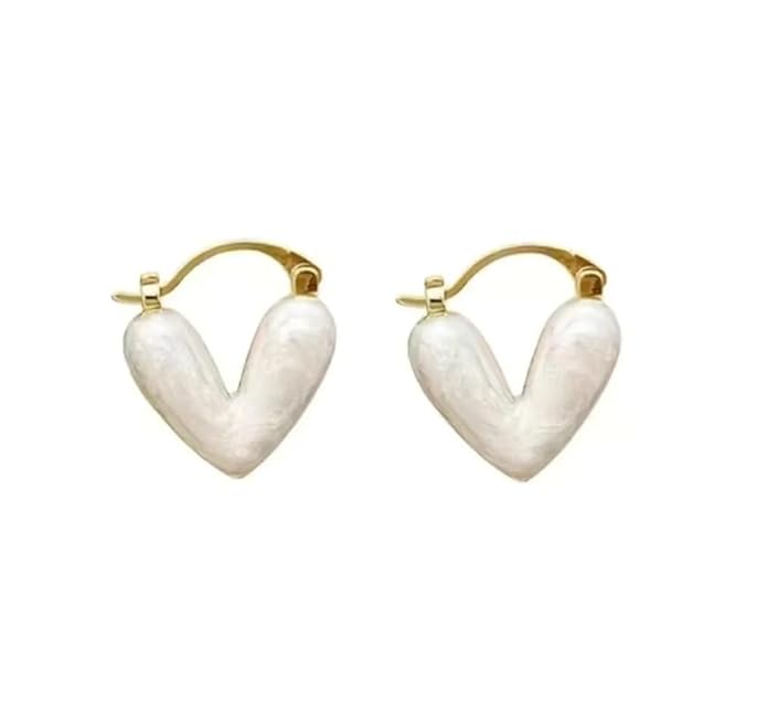 Chic white heart-shaped earrings on a beige surface, adding a subtle charm to your ensemble.