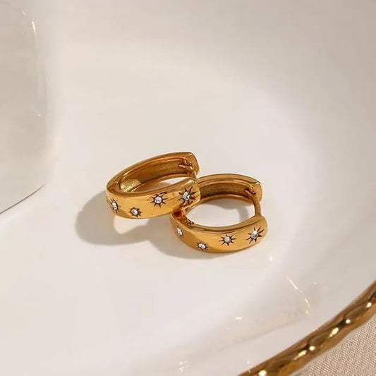 Stylish gold hoop earrings adorned with dazzling diamonds, ideal for a glamorous look.