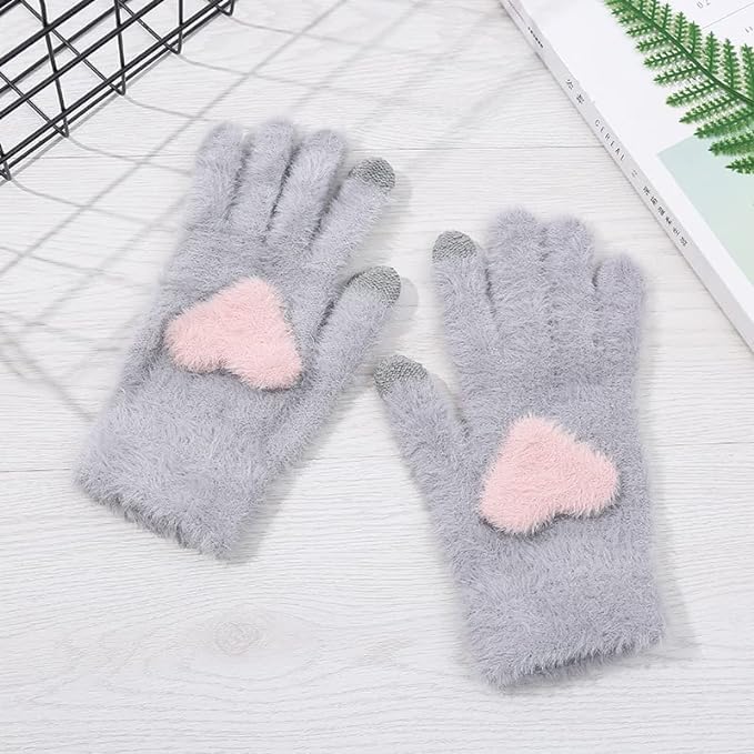 Two pairs of gloves adorned with heart patterns, showcasing a playful and loving design perfect for chilly days.