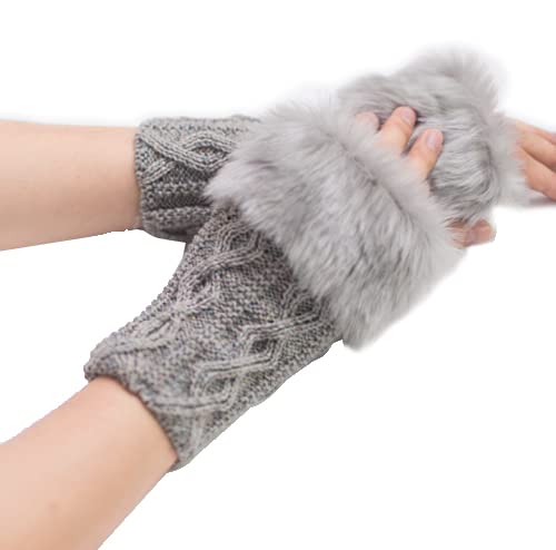 A close-up of a woman's hands in grey knitted gloves adorned with soft fur cuffs, showcasing warmth and style.