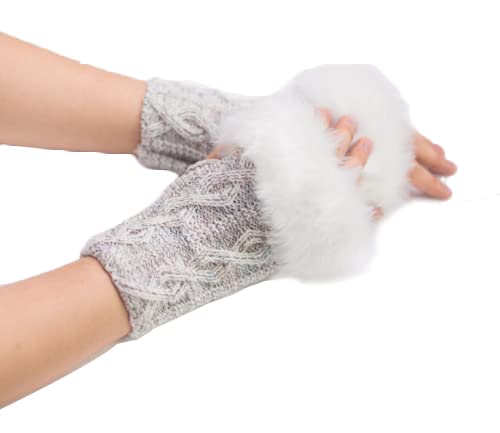 A close-up of a woman's hands adorned with elegant white gloves featuring a soft fur trim.