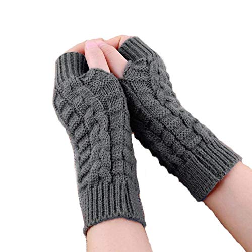 A close-up of hands in grey knitted fingerless gloves, showcasing warmth and comfort in a cozy setting.