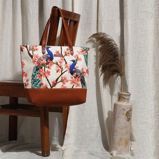A tote bag adorned with vibrant birds and flowers.