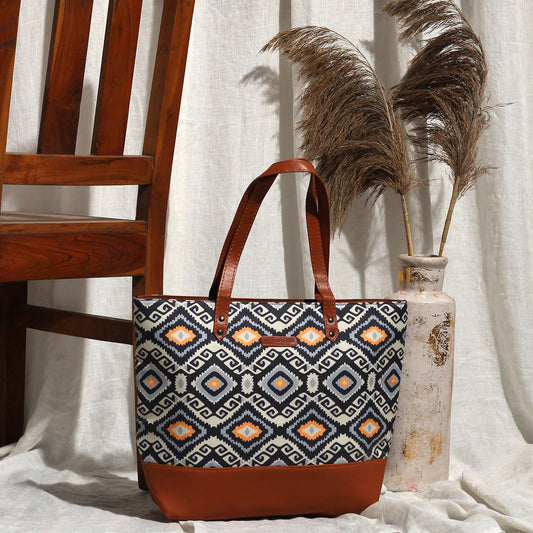 Stylish large tote bag with a bold blue and orange design, ideal for shopping or a day out.