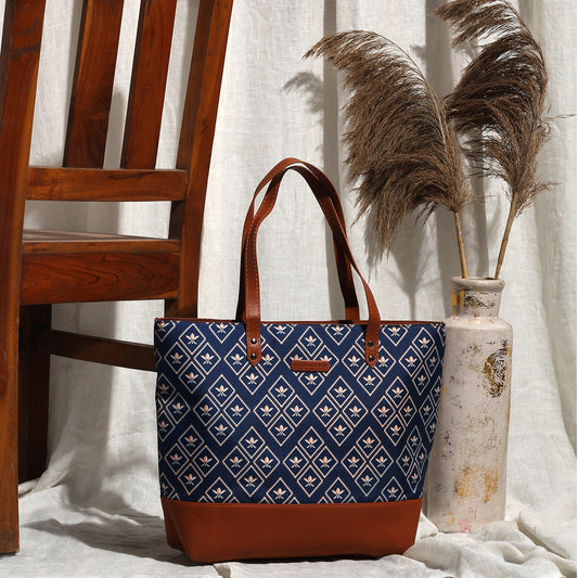 Geometric patterned navy and tan tote bag.