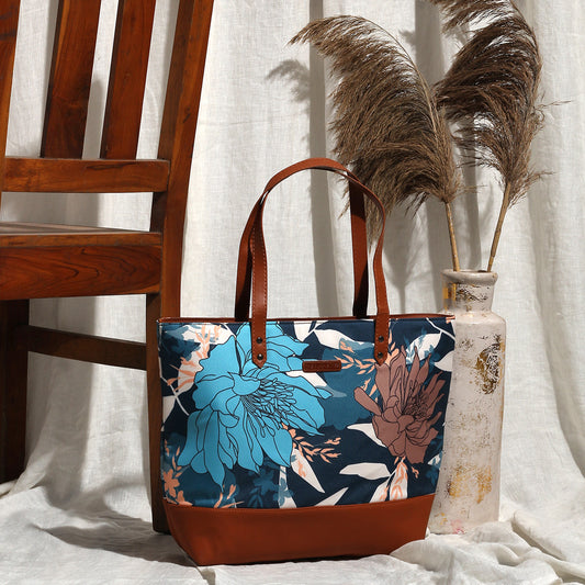 Chic leather tote with floral design and brown handle.