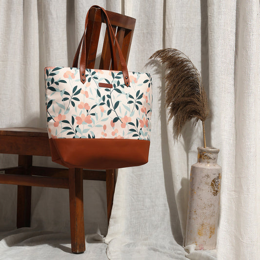 Floral print leather tote bag with a brown handle, combining elegance and practicality for your daily adventures.