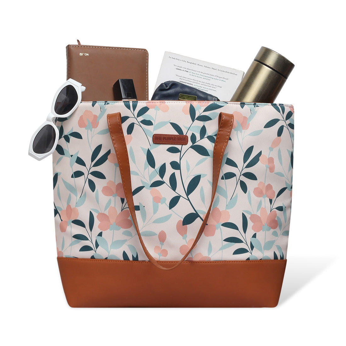 A stylish floral print tote bag with brown handles.