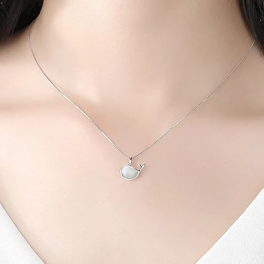 White pearl necklace resting on white box, luxurious accessory.