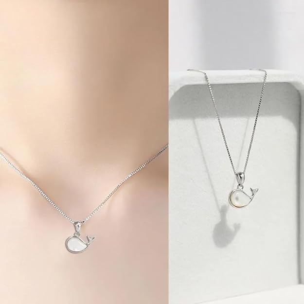 White pearl necklace displayed on a white box.