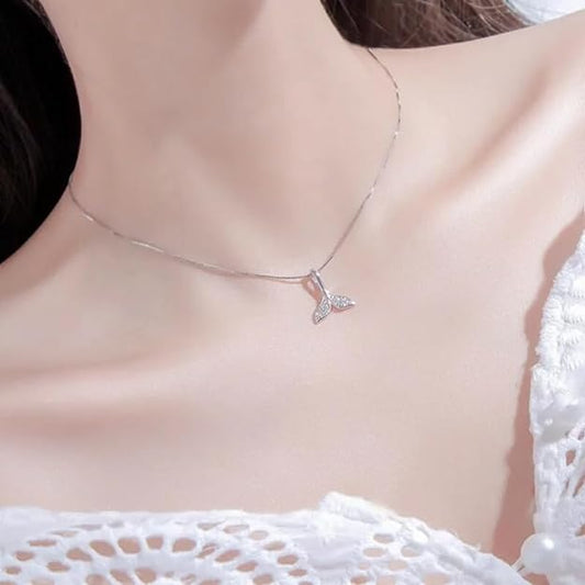 Whale tail charm on a silver necklace, ideal for marine enthusiasts.