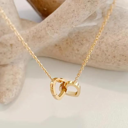 Elegant gold necklace featuring a red heart charm, symbolizing love and passion.