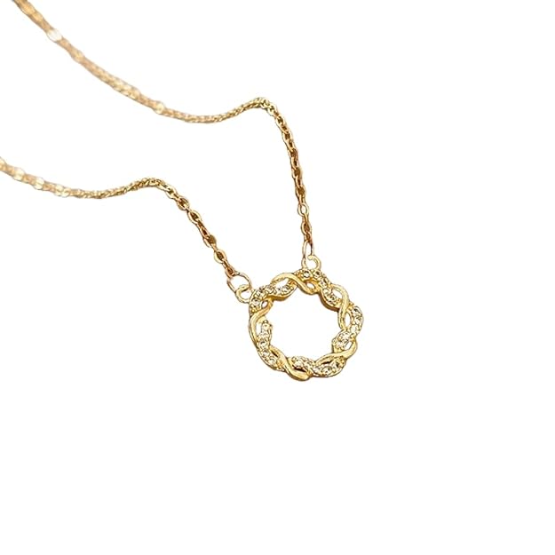 Gold necklace with circular pendant, elegant jewelry piece for special occasions.