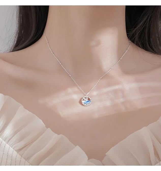 Silver chain necklace adorned with a beautiful blue whale pendant.
