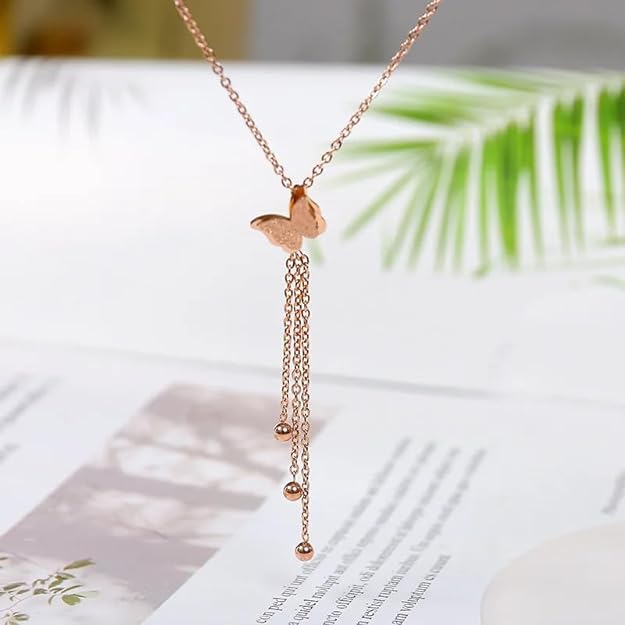 Shiny gold necklace with delicate butterfly charm, a stunning accessory.