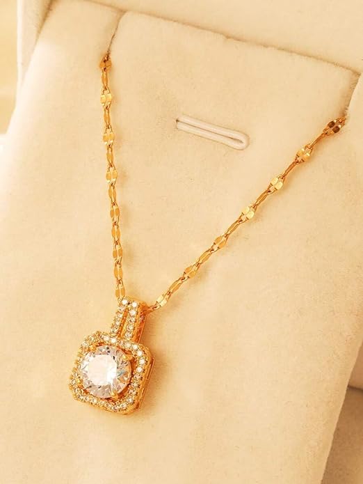A luxurious gold necklace featuring a diamond pendant.