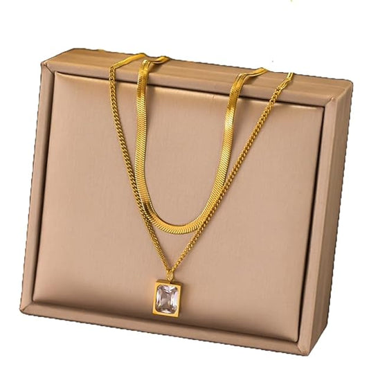 Gold necklace with square pendant in gift box, perfect for special occasions.