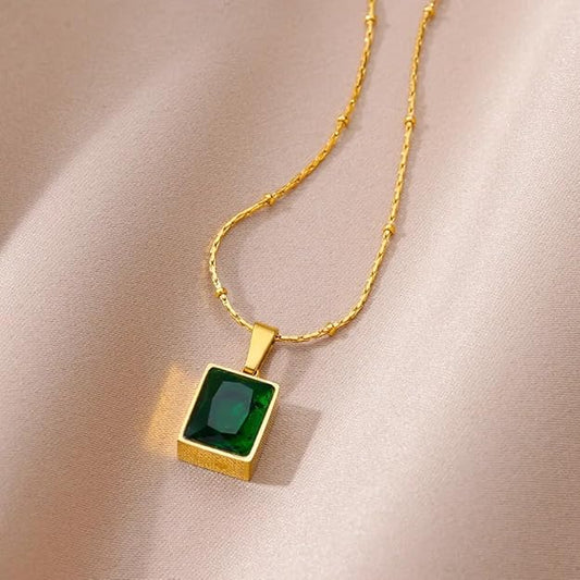 Luxurious square pendant with emerald stone, gold plated for a touch of sophistication.