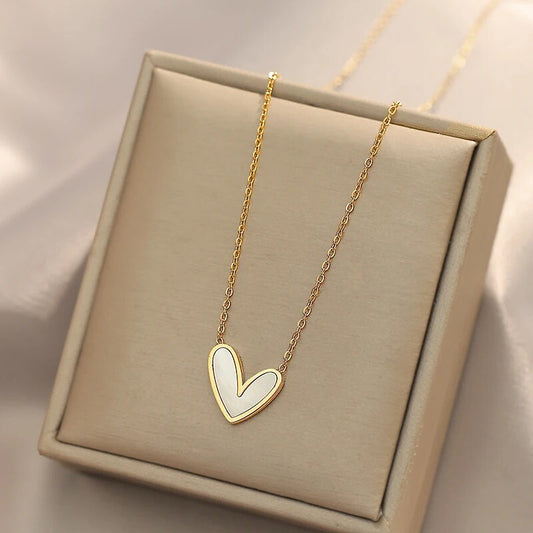 Elegant gold heart necklace featuring a white enamel pendant, a timeless accessory for any occasion.