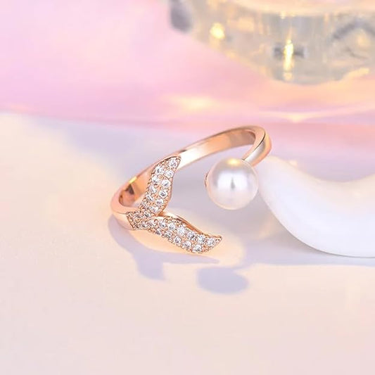 A ring with a gold finish, pearl, and diamond