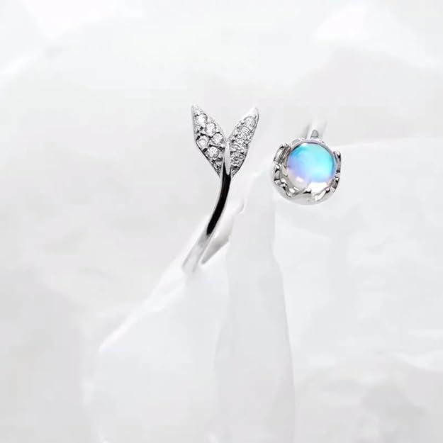 A lovely ring with a blue moonstone and a sparkling diamond centerpiece.