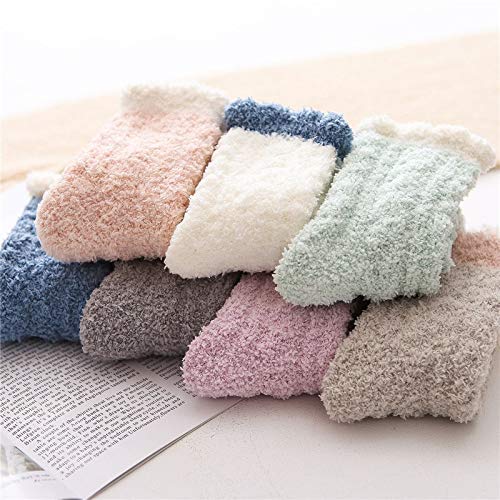 A woman enjoys a comfy moment on a blanket, her vibrant socks adding a pop of color.