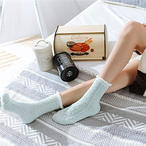 A woman lounges on a soft blanket, showing off her fun, patterned socks.