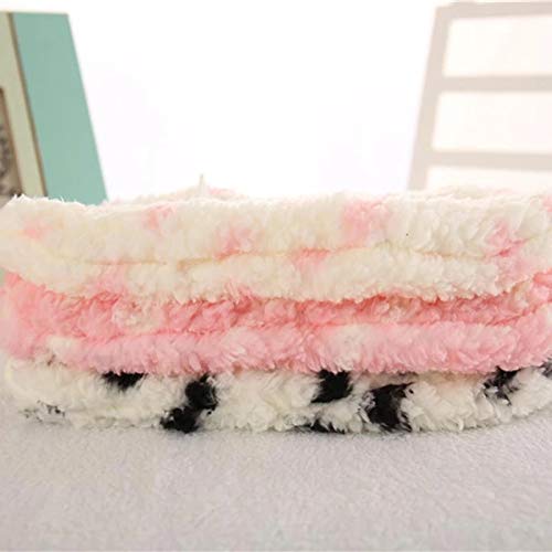 A pair of feet in pink fuzzy slippers, highlighting a casual and cozy home environment.