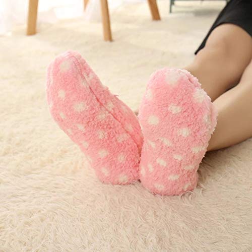 Close-up of a woman's feet adorned in plush pink fuzzy slippers, emphasizing comfort and warmth.