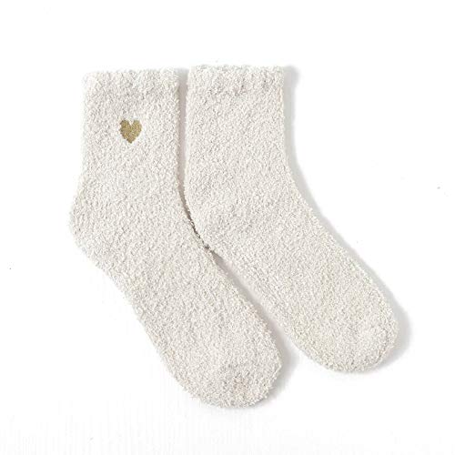 A pair of white socks featuring a cute gold heart design, perfect for adding a touch of love to your outfit.