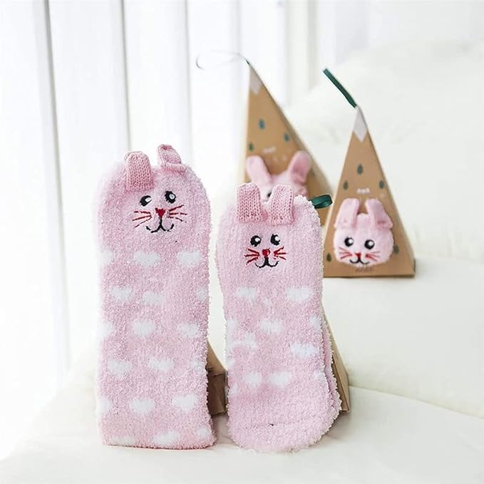 Two pairs of cute pink socks adorned with white hearts, perfect for adding a fun touch to your outfit.