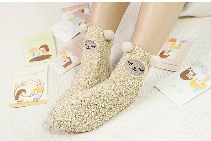 Two pairs of whimsical socks showcasing charming cat faces, bringing a touch of fun and warmth to your wardrobe.