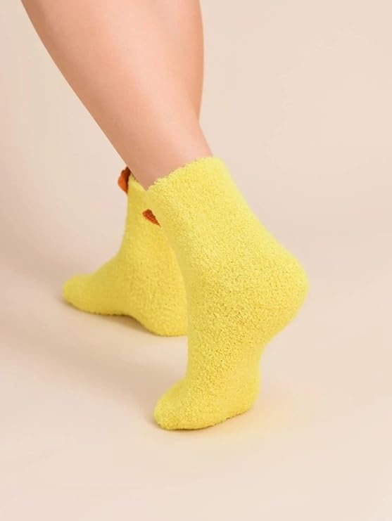 A woman sporting bright yellow socks featuring a cute chicken face design, adding a fun touch to her outfit.