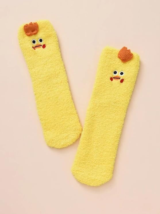 A woman shows off her yellow socks featuring adorable chicken faces, adding a fun touch to her outfit.
