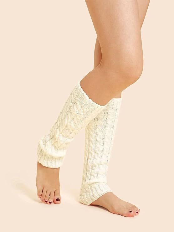A woman in white leg warmers sits with her legs crossed, showcasing a stylish and relaxed pose.