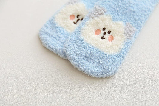 Soft blue blanket adorned with a charming bear, ideal for snuggling up on chilly days