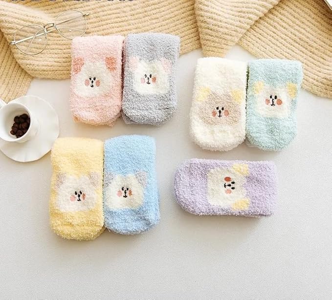 Two pairs of scissors positioned next to a colorful pair of socks, creating an intriguing visual contrast.