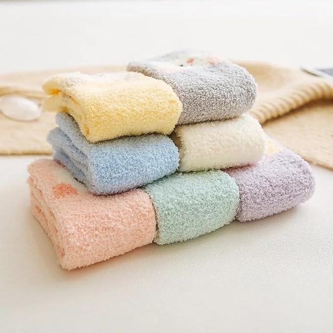 Two pairs of scissors flanking a pair of socks, presenting an interesting and unconventional visual arrangement.