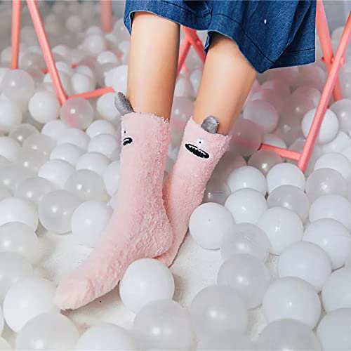 A pink sock featuring a playful monster face, showcasing vibrant colors and whimsical design.