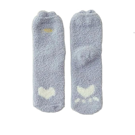 Close-up of a person's feet in playful socks decorated with fluffy clouds, brightening up their look.