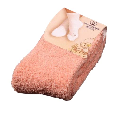 Two orange socks positioned on a table, showcasing their striking color and inviting texture.