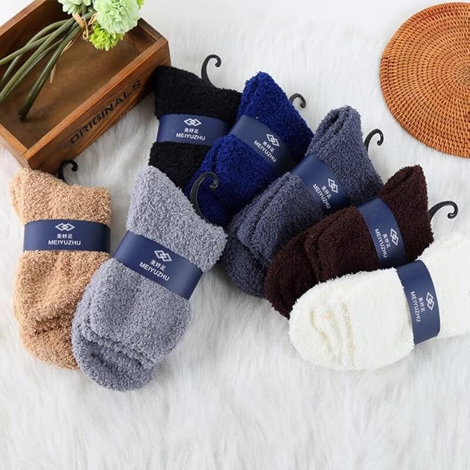 A pair of cozy blue fuzzy socks placed next to a rustic wooden box, showcasing comfort and style.