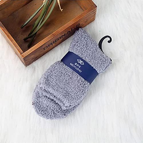 A person relaxing in cozy grey fuzzy socks, perfect for keeping warm and comfy at home.