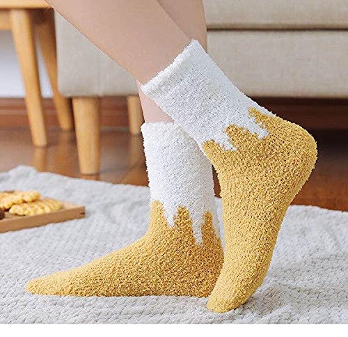 A pair of yellow and white socks laid out, showcasing their vibrant colors and soft fabric.