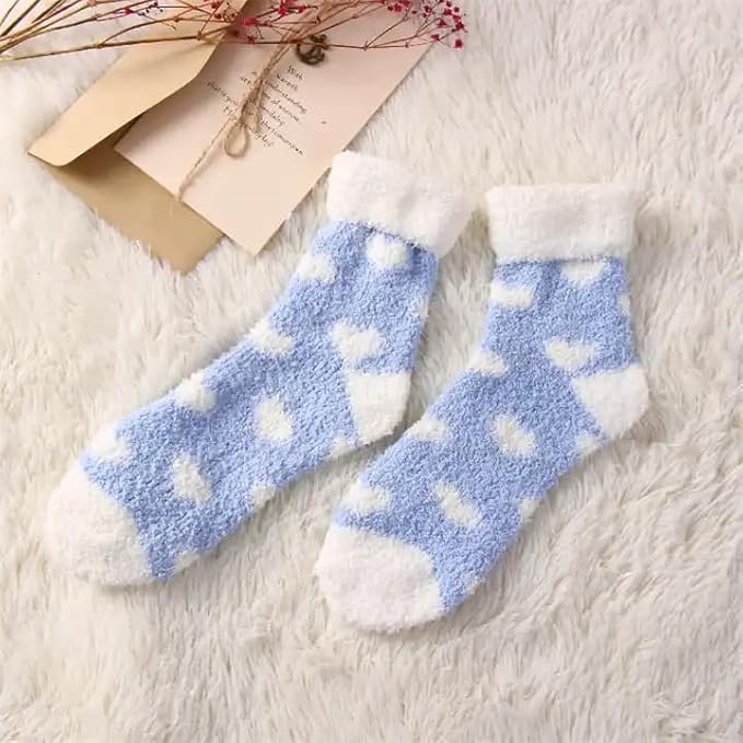 A pair of blue and white socks adorned with playful heart patterns, perfect for adding a touch of whimsy to any outfit.