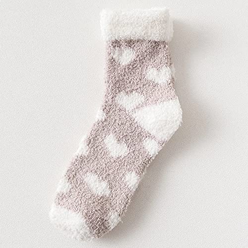 A woman's feet in playful heart-patterned socks, adding a fun touch to her casual look.